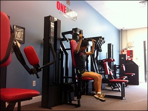 Emma performing the MedX Shoulder Press